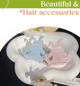 Detailed view of acetate hair claws in cute rabbit shapes with pearl bead embellishments