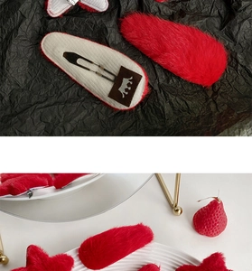 Detail of red plush teardrop BB hair clips with soft faux fur and silver metal backing