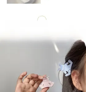 Detailed shot of acetate rabbit hair clips with pearls in blue and pink colors