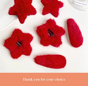 Detail of red plush star and oval hair clips with soft faux fur and metal base