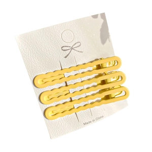 Three-piece set of yellow wave-shaped candy colored hair clips on white card