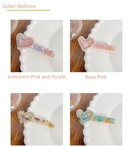 Detail of acetate heart hair clips with marble texture and sparkling rhinestone edges