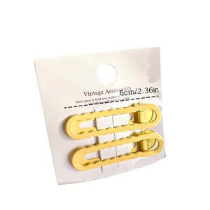 Lot de deux barrettes à cheveux ondulées couleur jaune bonbon sur carte d'affichage