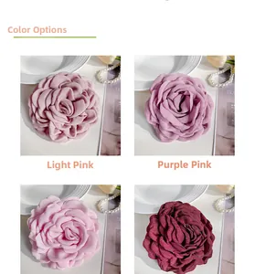 Detail view of handmade fabric rose hair clips in dusty pink and purple color options