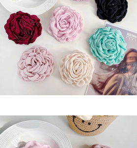 Detailed macro view of handmade satin rose hair clips in multiple vibrant colors