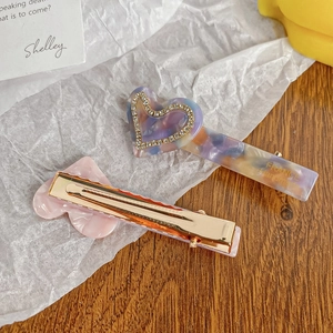 Elegant heart-shaped acetate hair clip set with sparkling rhinestones and metal grip