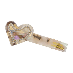 Elegant heart acetate hair clip with marble texture and rhinestones in cream white finish
