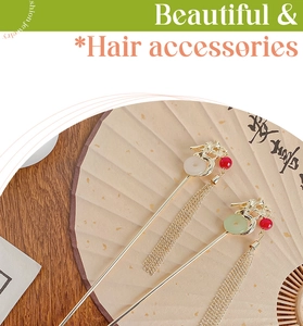 Macro detail of golden dragon hair pins with jade-like rings and flowing metal tassels