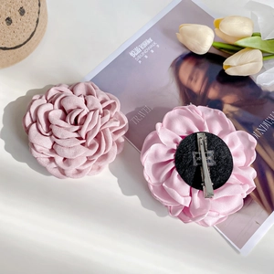 Handmade fabric rose hair clip in pink shades featuring metal alligator clip base