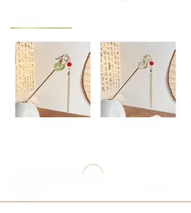 Detailed view of dragon hairpins with jade rings and long metallic tassels in gold