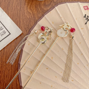 Elegant Chinese dragon hairpin with golden tassels and red beads on traditional fan base