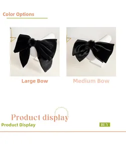 Comparison of medium and large black velvet bow hair clips with soft pom-pom centers