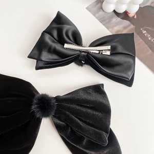 Elegant black velvet and satin bow hair clips featuring a French vintage style design