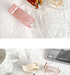 Selection of colorful trendy resin hair claws in pink, cream and tortoiseshell patterns