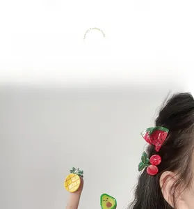 Detailed view of various fruit-shaped acetate hair claws including pineapple and cherry