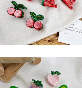 Close-up of mini acetate fruit hair claws featuring cherry, strawberry, and grape designs