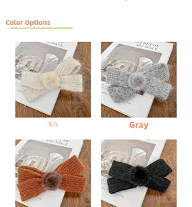 Detail of four knitted bow hair clips in beige, grey, brown, and black with faux fur poms