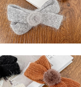 Macro shot of knitted bow hair clips with plush pom-poms in grey, tan, and black