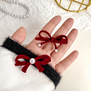 Pair of red velvet bow hair clips with white pearls in a vintage elegant style