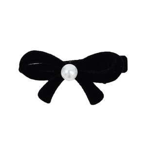 Elegant black velvet bow hair clip with a centered pearl for classic feminine hair styling