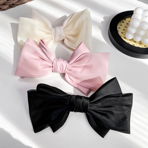 Three elegant French style satin bow hair clips in cream, pink and black colors