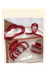 Detailed set of four wine red resin hair claw clips in various geometric shapes and designs