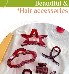 Detailed view of red translucent acrylic hair claw clips in star and cloud shapes