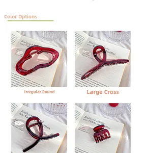 Detail of four deep red acrylic hair claws showing irregular round and cross-type designs