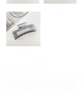 Macro detail of large transparent smoke grey rectangle claw clip with metal spring