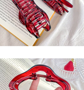 Detail of burgundy tortoiseshell resin hair claw clips with elegant vintage texture