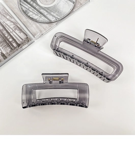 Close-up of translucent smoke gray rectangular hair claw clip with a sleek matte finish