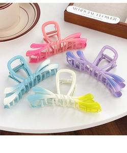 Detail of elegant gradient butterfly hair claws in pink, purple, blue and yellow tones