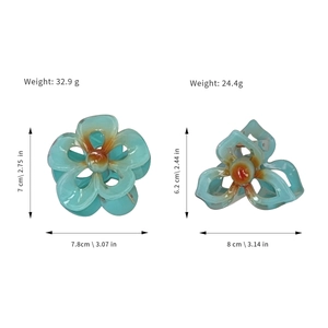 Pinces à cheveux fleur de frangipanier bleues en deux tailles avec centre dégradé orange
