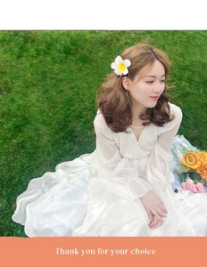 Detail of elegant white chiffon floral maxi dress with long sleeves and V-neck design