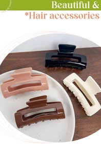 Detail view of large rectangular hair claws in black, cream, pink and brown finishes