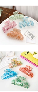 Detail of colorful acetate hair claws in marble and glitter patterns for thick hair