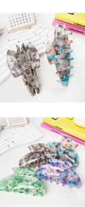Detail of premium large acetate hair claws in assorted marble and floral patterns
