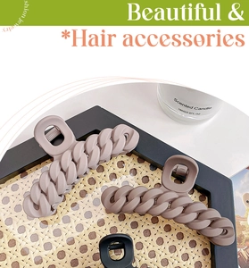 Detailed view of matte chain-link hair claws in purple, brown, and black colors