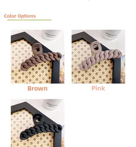 Close-up of matte chain texture hair claws in brown, pink, and black colors