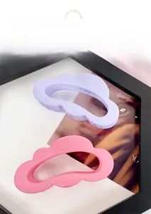 Detail showing matte purple and pink cloud-shaped hair claws on a fashion magazine