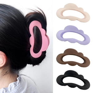 Matte cloud-shaped hair claw clips in five colors shown on model and flat lay