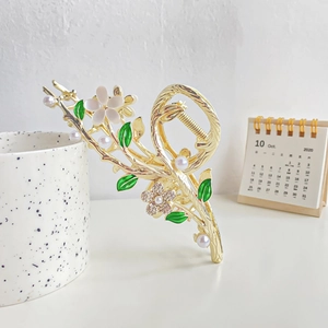 Golden daisy hair claw clip with white pearls and sparkling rhinestone flower details