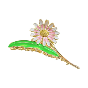 Elegant gold daisy hair claw clip with pink enamel flowers and sparkling yellow crystals