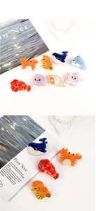 Vue détaillée de diverses barrettes en acétate sur le thème marin avec animaux colorés