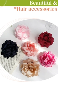 Detailed macro view of six elegant satin fabric flower hair claws in multiple soft colors