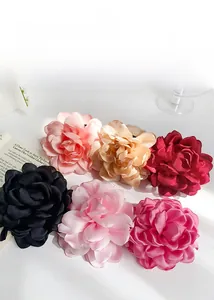 Detailed top view of blooming fabric flower hair claws in six vibrant satin colors