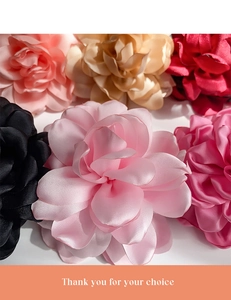 Macro detail of multi-color satin flower hair clips with silky layered fabric petals