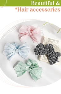 Close-up of four assorted elegant fabric bow scrunchies in pastel colors and patterns