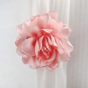 Chic pink flower hair claw clip accessory on a white curtain for elegant styling