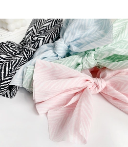 Detailed view of elegant bow fabric hair scrunchies in pastel colors and ripple patterns